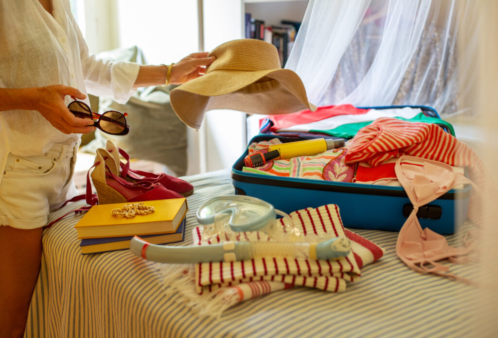 Woman packing suitcase for a yacht holiday